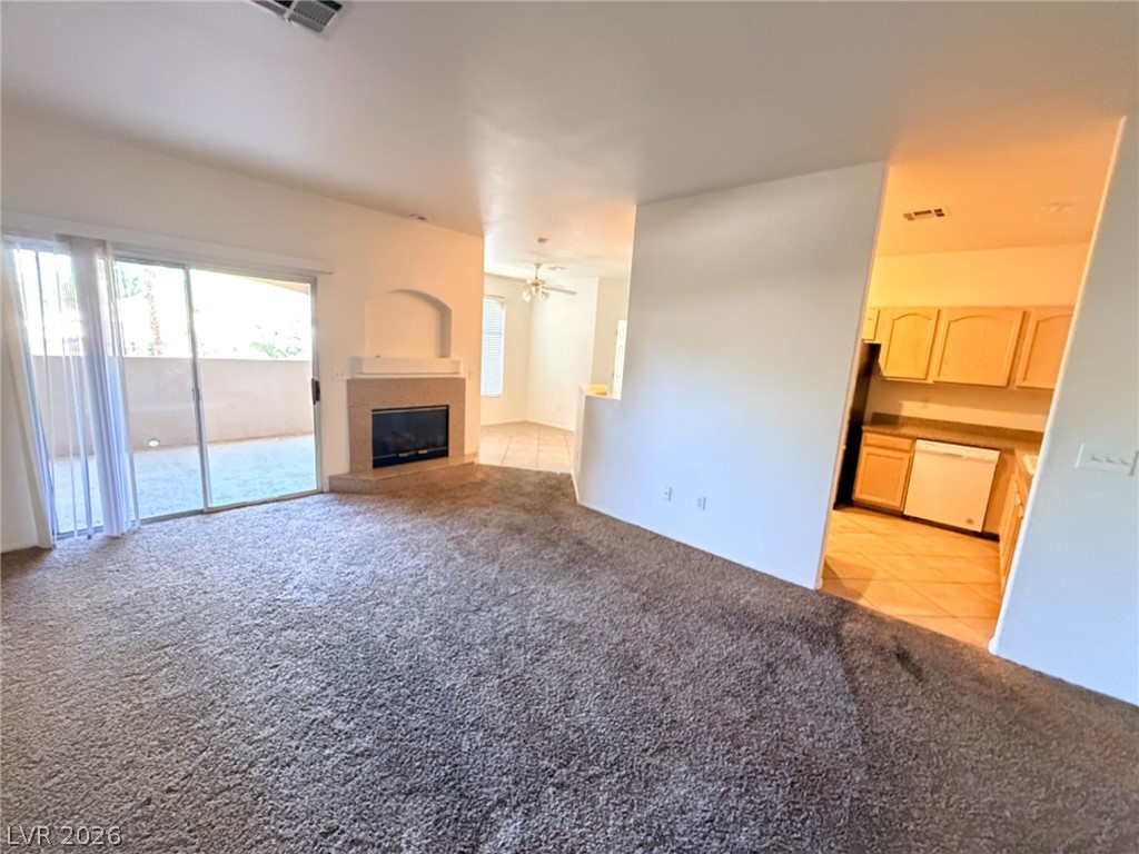 2050 West Warm Springs Road, Unit 3521 Henderson, NV 89014 - Photo 7 of 12 A spacious great room features a cozy fireplace and direct access to an outdoor patio.