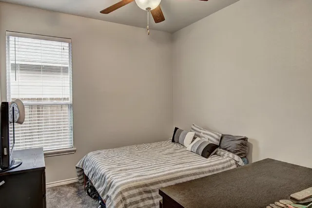a bedroom with a bed and a flat tv screen