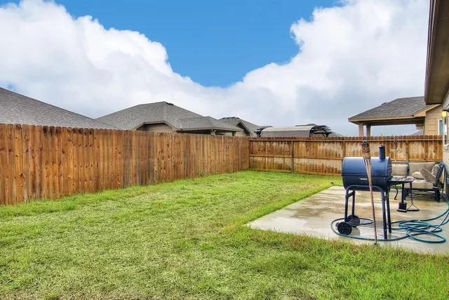 a view of a backyard with sitting area