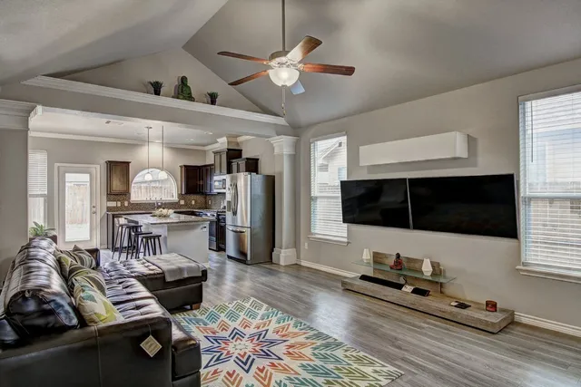 a living room with furniture and a flat screen tv