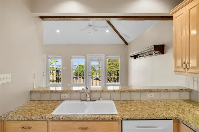 a kitchen with sink cabinets and window