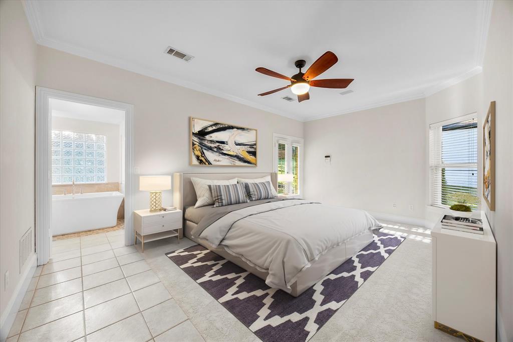 5411 Ranger Drive Rockwall, TX 75032 - Photo 13 of 33 a bedroom with a bed a couch and a window