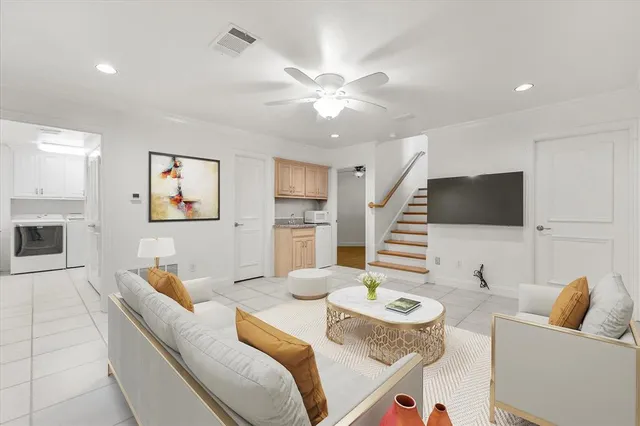 a bunch of flowers in front of yellow house