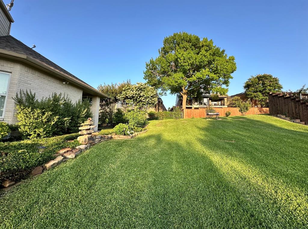 5411 Ranger Drive Rockwall, TX 75032 - Photo 24 of 33 a view of a backyard with plants and a garden