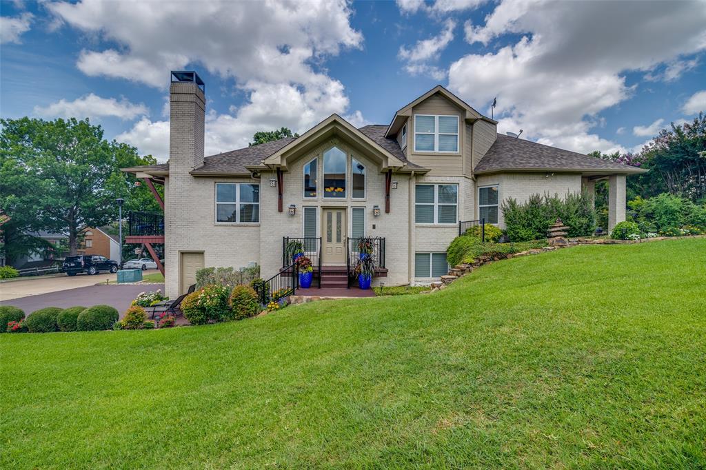 5411 Ranger Drive Rockwall, TX 75032 - Photo 4 of 33 a front view of a house with a garden and plants