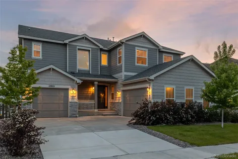 a front view of a house with a garden and plants