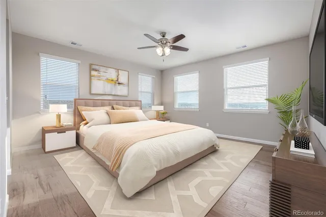 a bedroom with a large bed and a chandelier