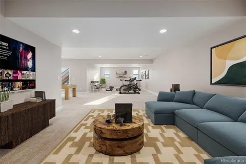 a living room with furniture a flat screen tv and a large window