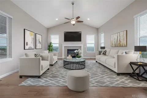 a living room with fireplace furniture and a flat screen tv