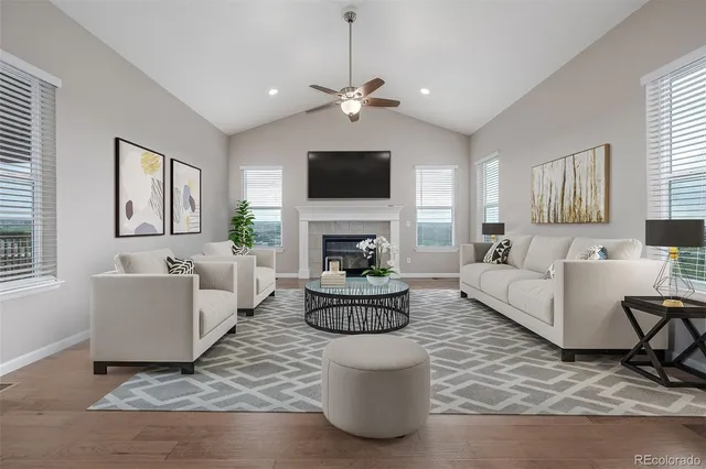 a living room with fireplace furniture and a flat screen tv