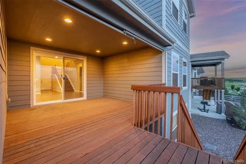 a view of outdoor space with wooden floor and iron stairs
