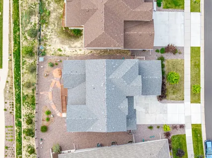 aerial view of a house with a yard and potted plants