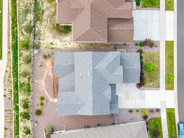 aerial view of a house with a yard and potted plants