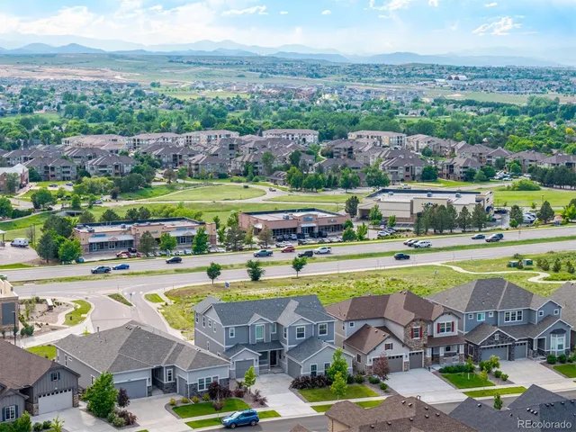 an aerial view of a swimming pool with outdoor seating and yard