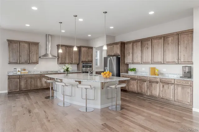 a kitchen with white cabinets and sink