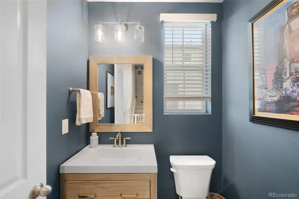 a bathroom with a sink a toilet and mirror