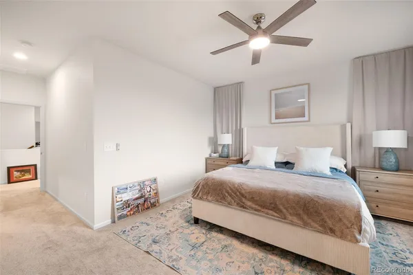 a bedroom with a bed and a ceiling fan