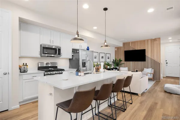 a large kitchen with a table and chairs