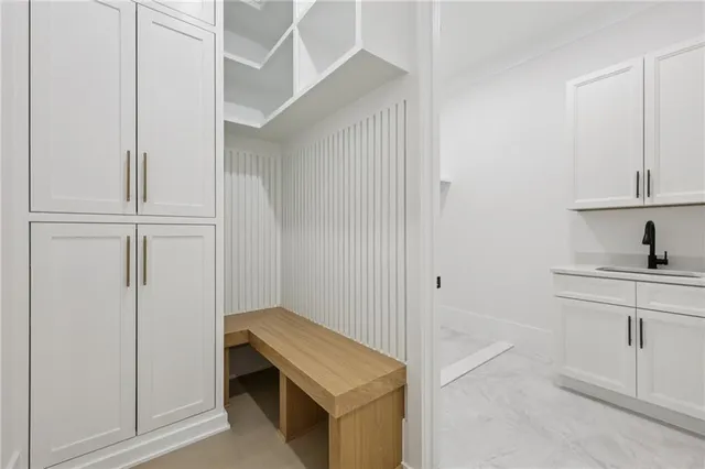 an empty room with windows and closet