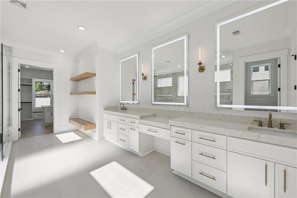 2395 Kilgore Road Buford, GA 30519 - Photo 29 of 68 a spacious bathroom with a granite countertop sink and a mirror