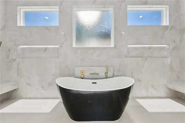 a bathroom with a double vanity sink toilet and shower