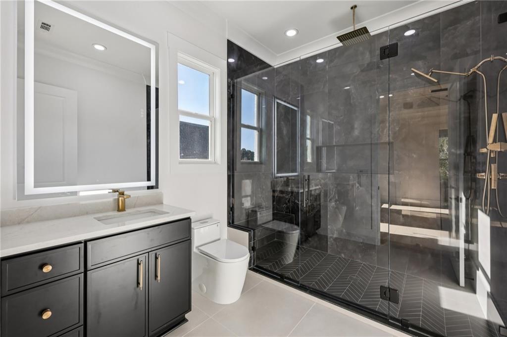 2395 Kilgore Road Buford, GA 30519 - Photo 37 of 68 a bathroom with a double vanity sink toilet and shower