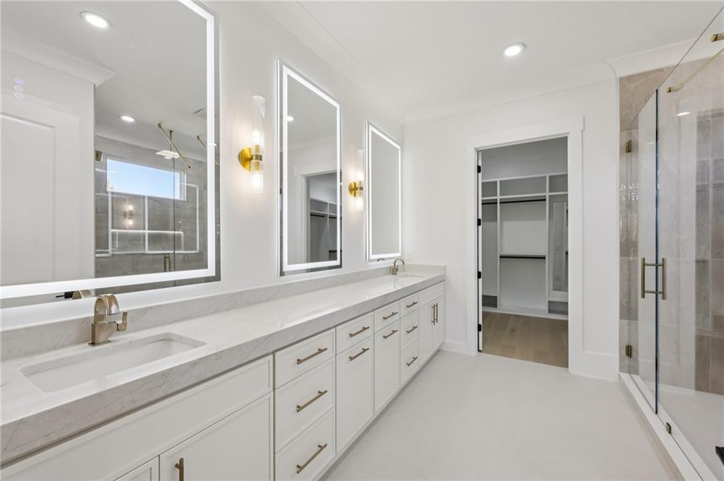 2395 Kilgore Road Buford, GA 30519 - Photo 41 of 68 a bathroom with a sink double vanity and a glass door