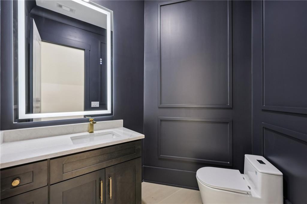 2395 Kilgore Road Buford, GA 30519 - Photo 46 of 68 a bathroom with a sink a toilet a mirror and vanity