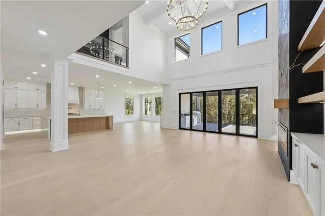 a view of an empty room with a fireplace and a window
