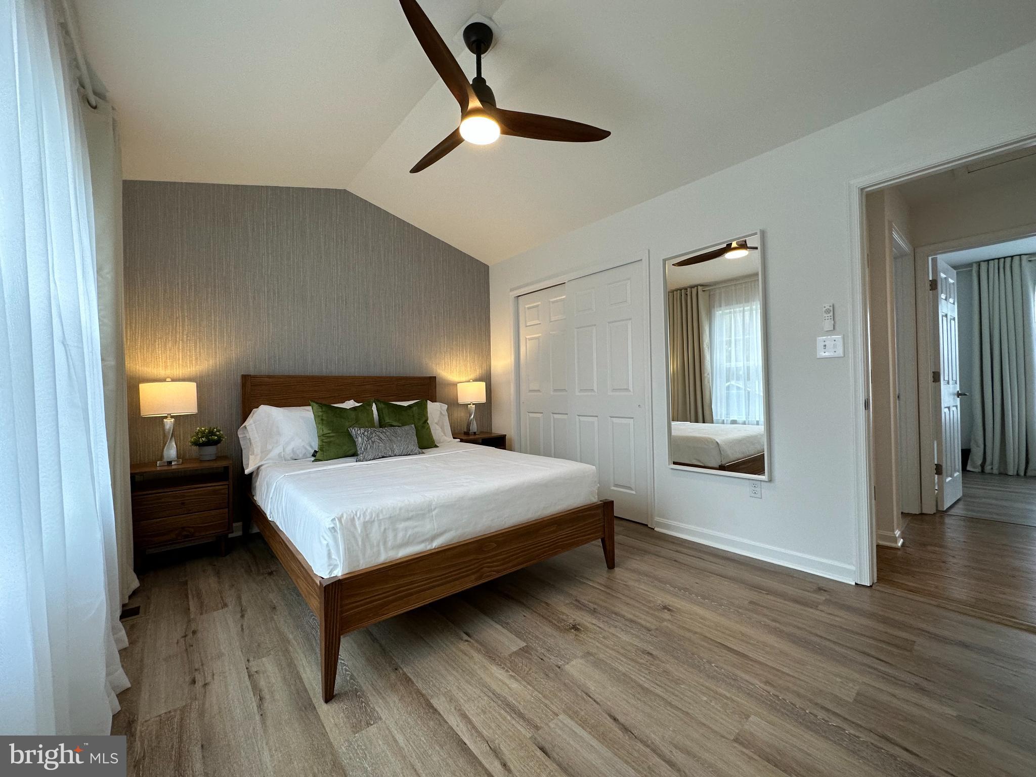 1221 Cox Neck Road Chester, MD 21619 - Photo 11 of 35 a bedroom with a bed and wooden floor