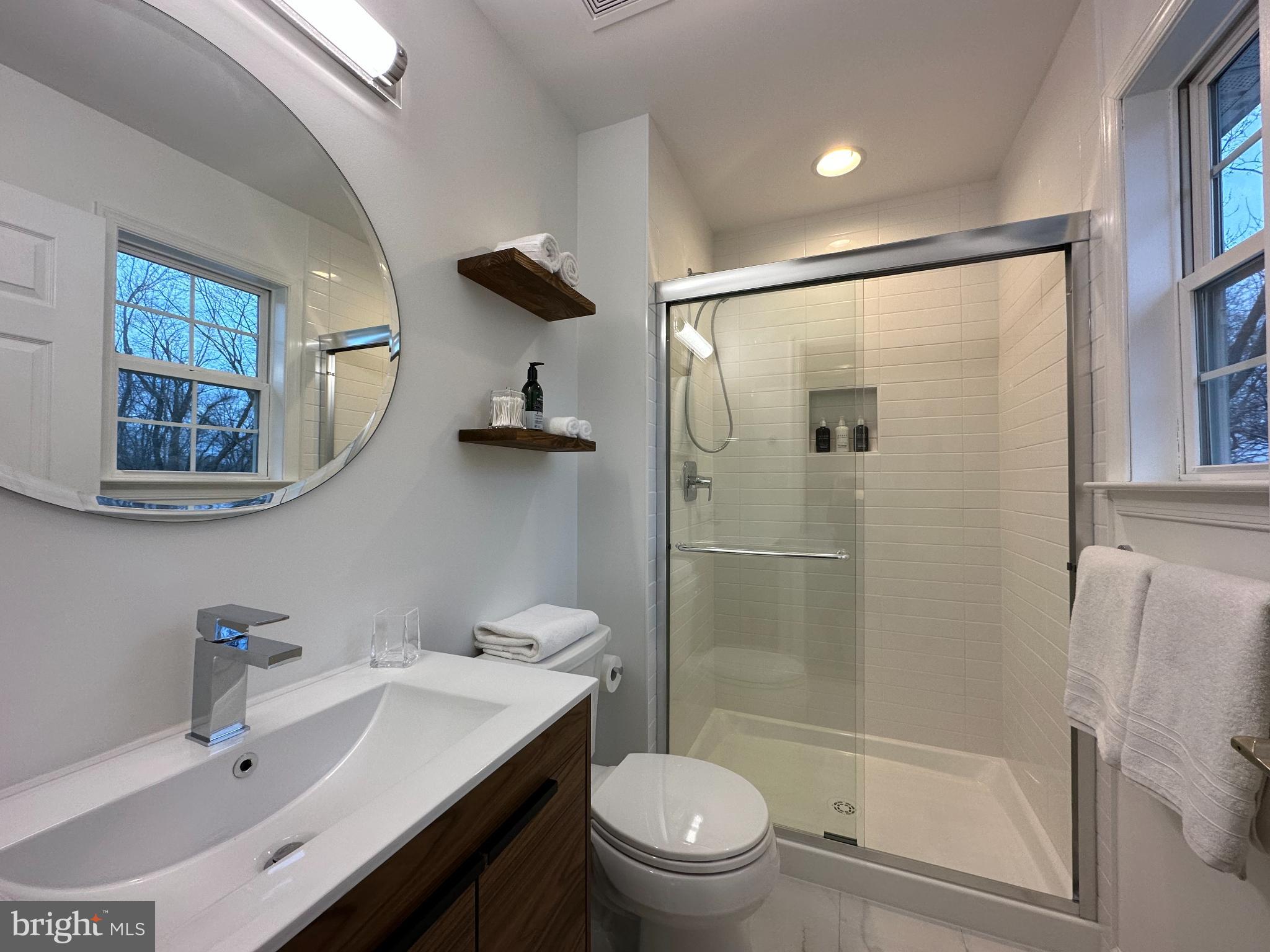 1221 Cox Neck Road Chester, MD 21619 - Photo 13 of 35 a bathroom with a sink mirror toilet and shower
