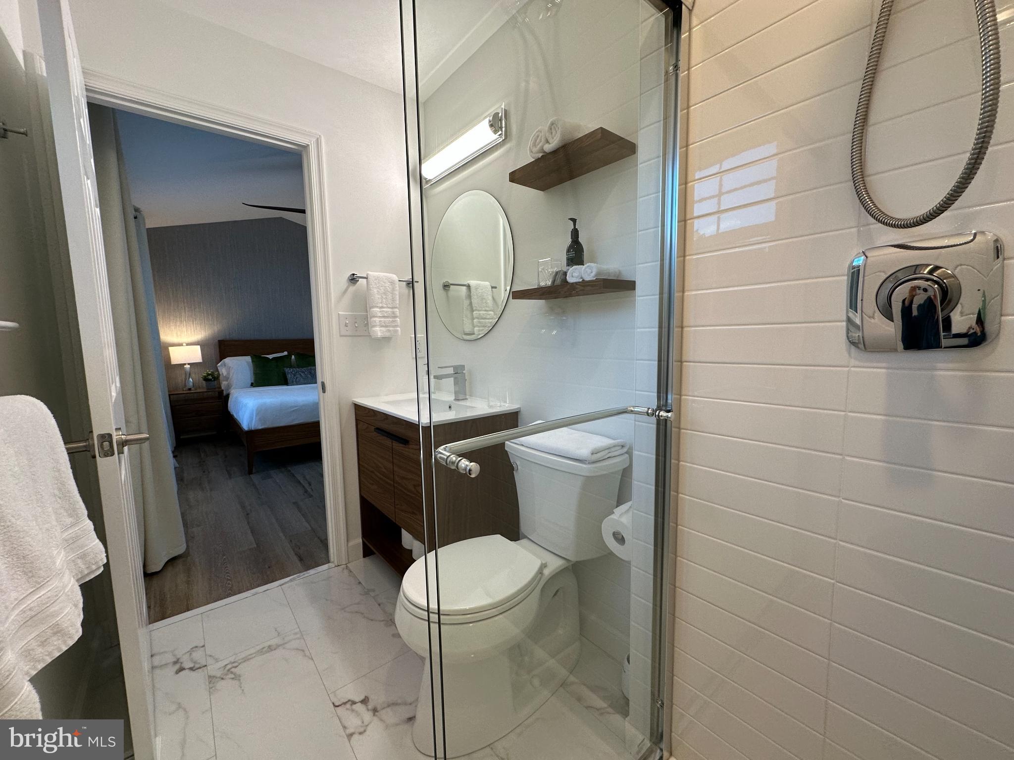 1221 Cox Neck Road Chester, MD 21619 - Photo 14 of 35 a bathroom with a toilet a sink and mirror