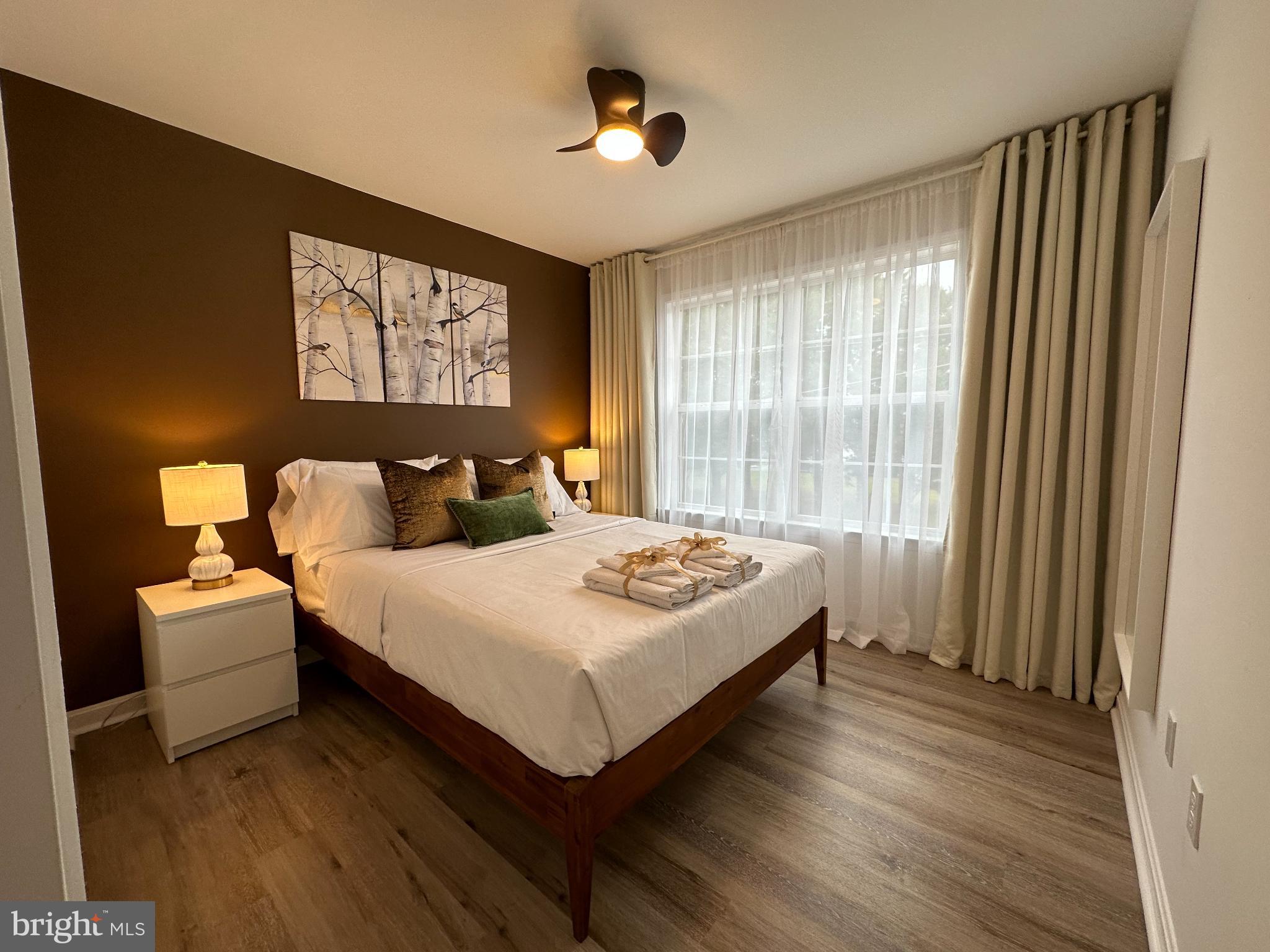 1221 Cox Neck Road Chester, MD 21619 - Photo 15 of 35 a bedroom with a bed and a large window