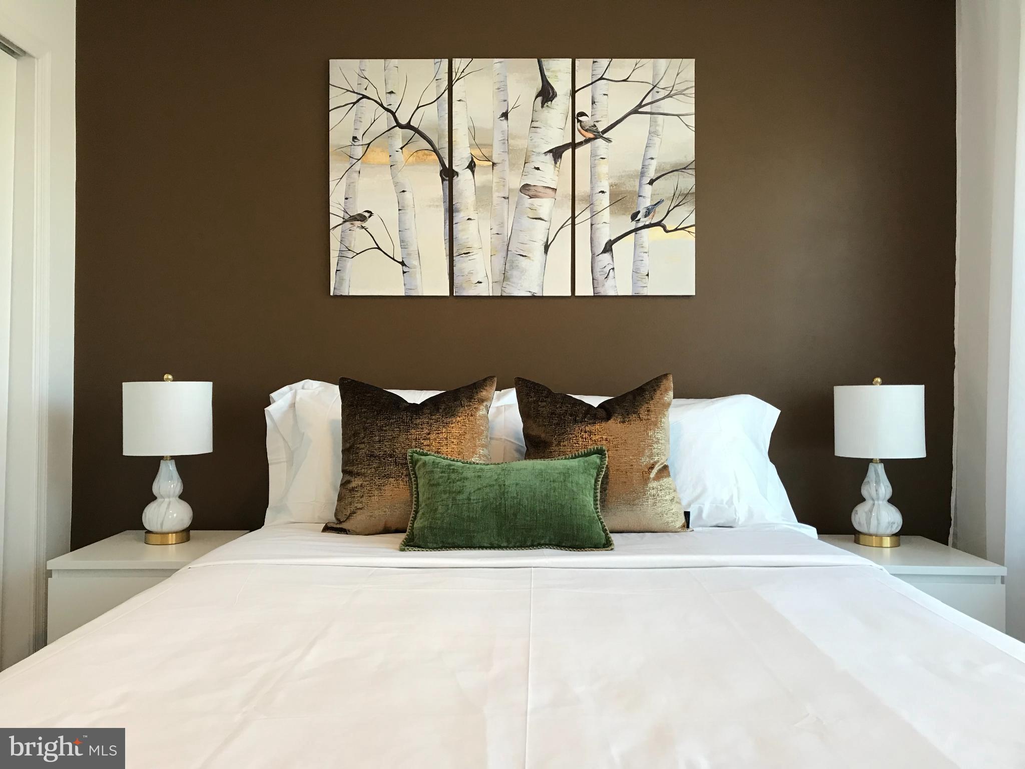 1221 Cox Neck Road Chester, MD 21619 - Photo 16 of 35 a bedroom with a bed and a painting on the wall