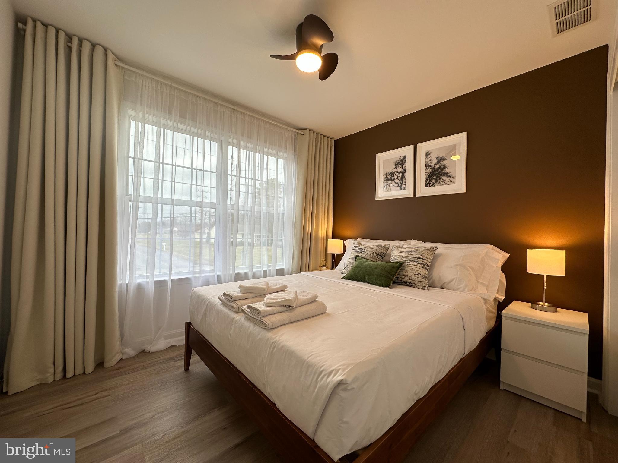 1221 Cox Neck Road Chester, MD 21619 - Photo 18 of 35 a bedroom with a bed and a window