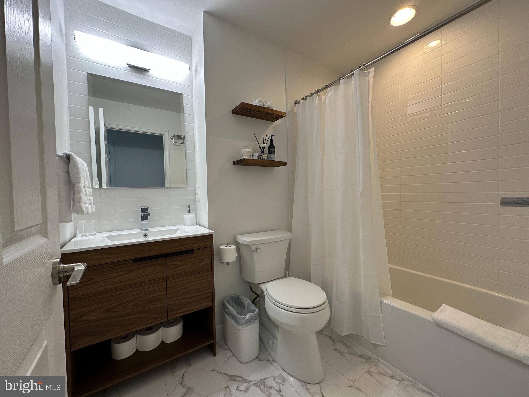 1221 Cox Neck Road Chester, MD 21619 - Photo 19 of 35 a bathroom with a sink a toilet and shower
