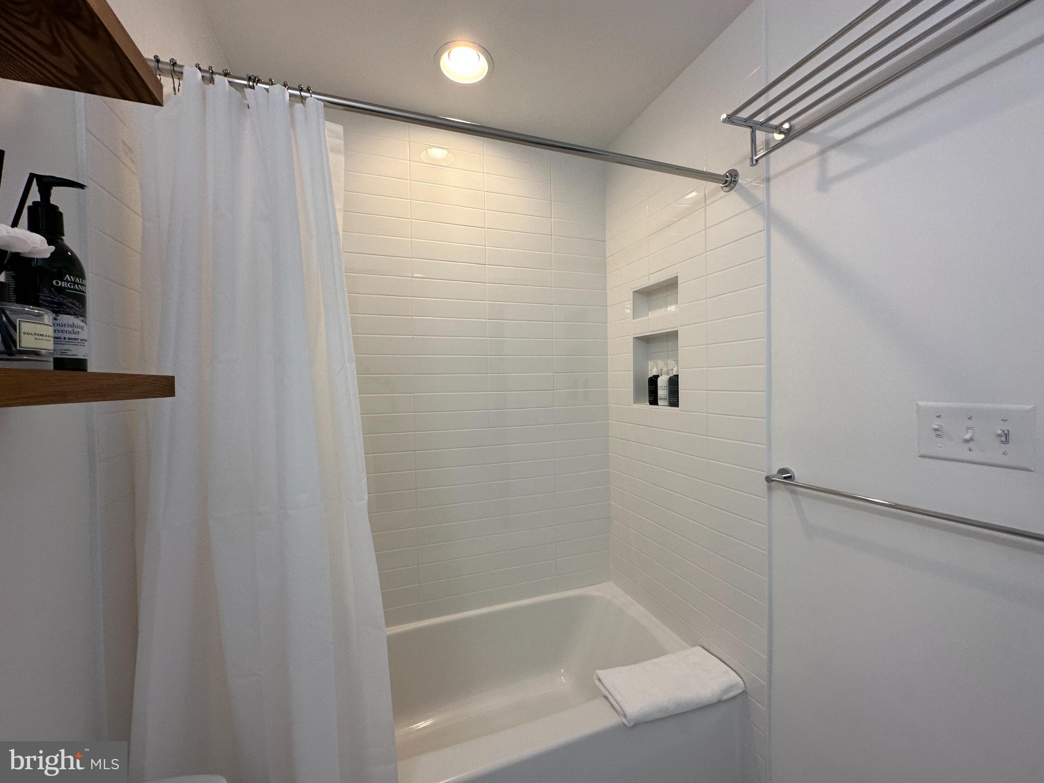 1221 Cox Neck Road Chester, MD 21619 - Photo 20 of 35 a bathroom with a shower and a tub