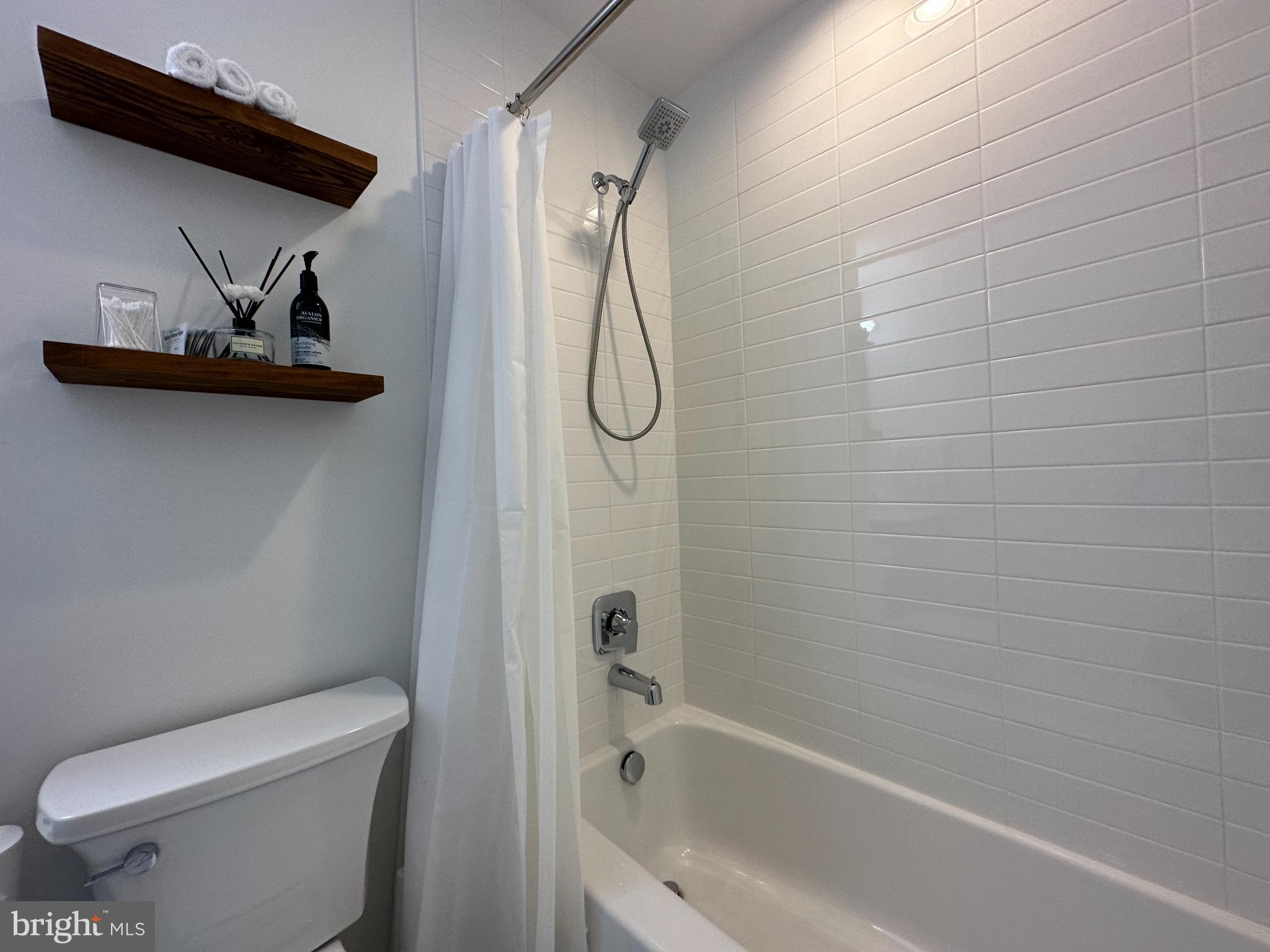 1221 Cox Neck Road Chester, MD 21619 - Photo 21 of 35 a bathroom with a toilet and a bathtub