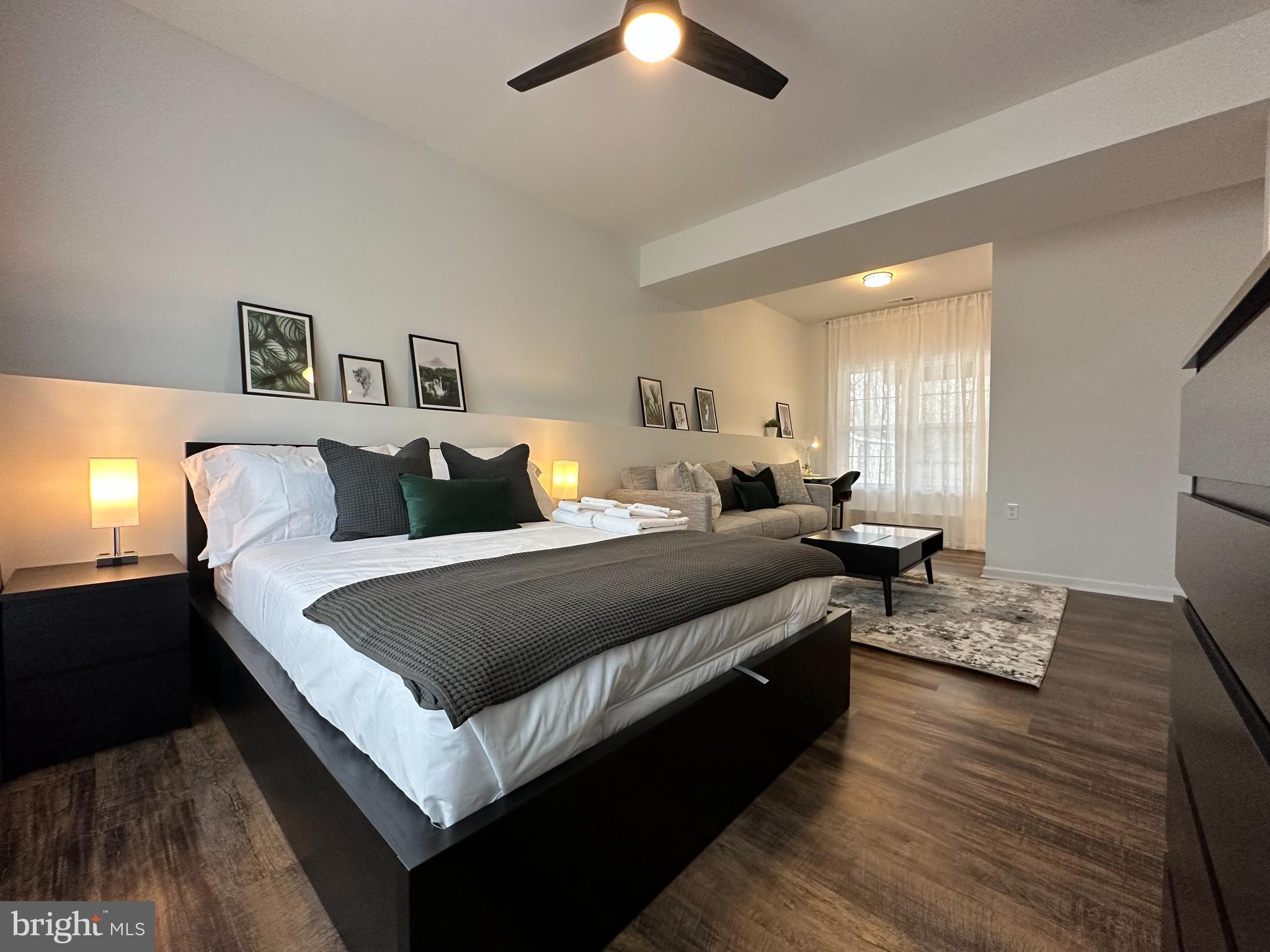 1221 Cox Neck Road Chester, MD 21619 - Photo 22 of 35 a large bedroom with bed and a chandelier