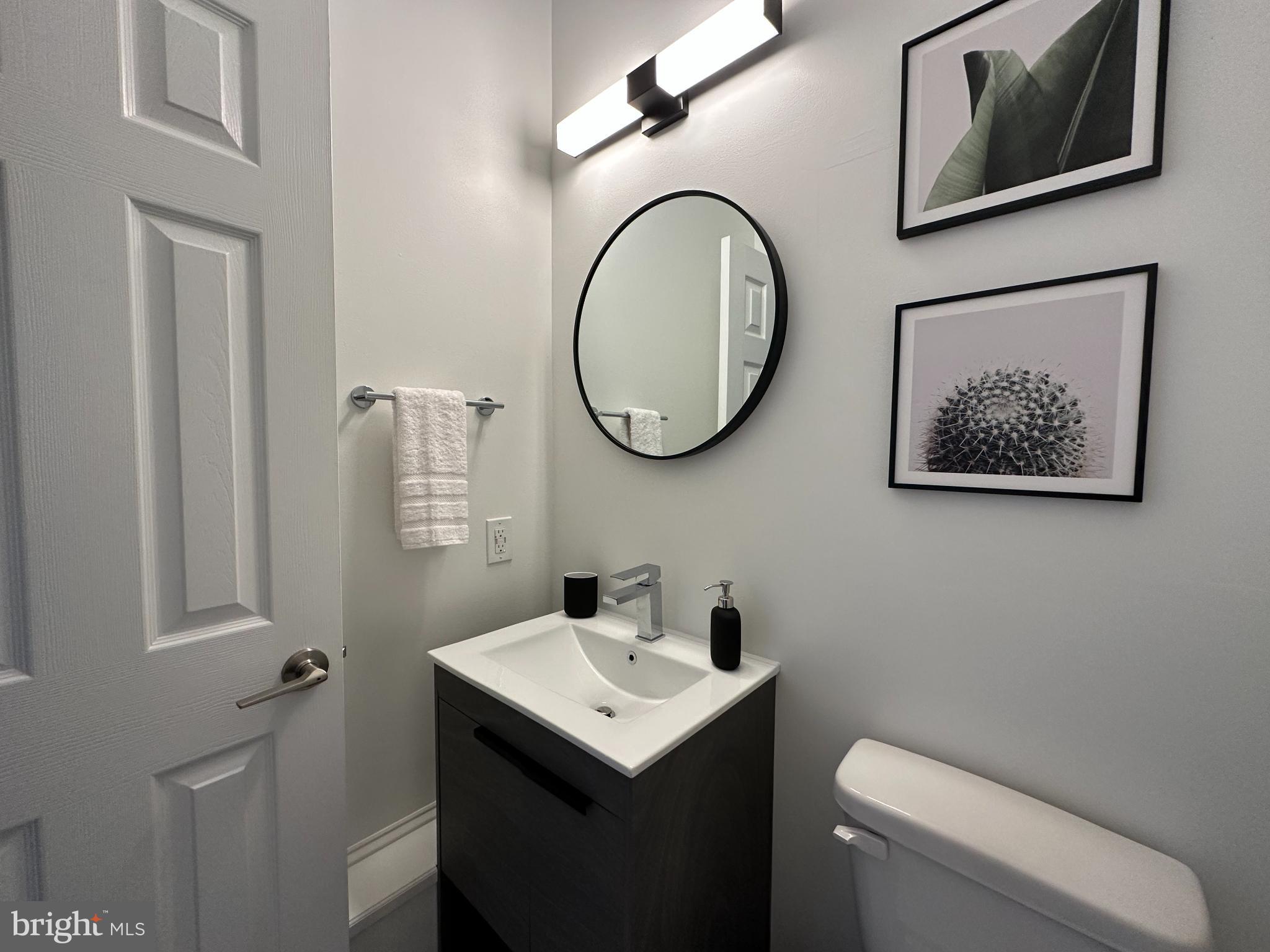 1221 Cox Neck Road Chester, MD 21619 - Photo 25 of 35 a bathroom with a toilet a sink and mirror