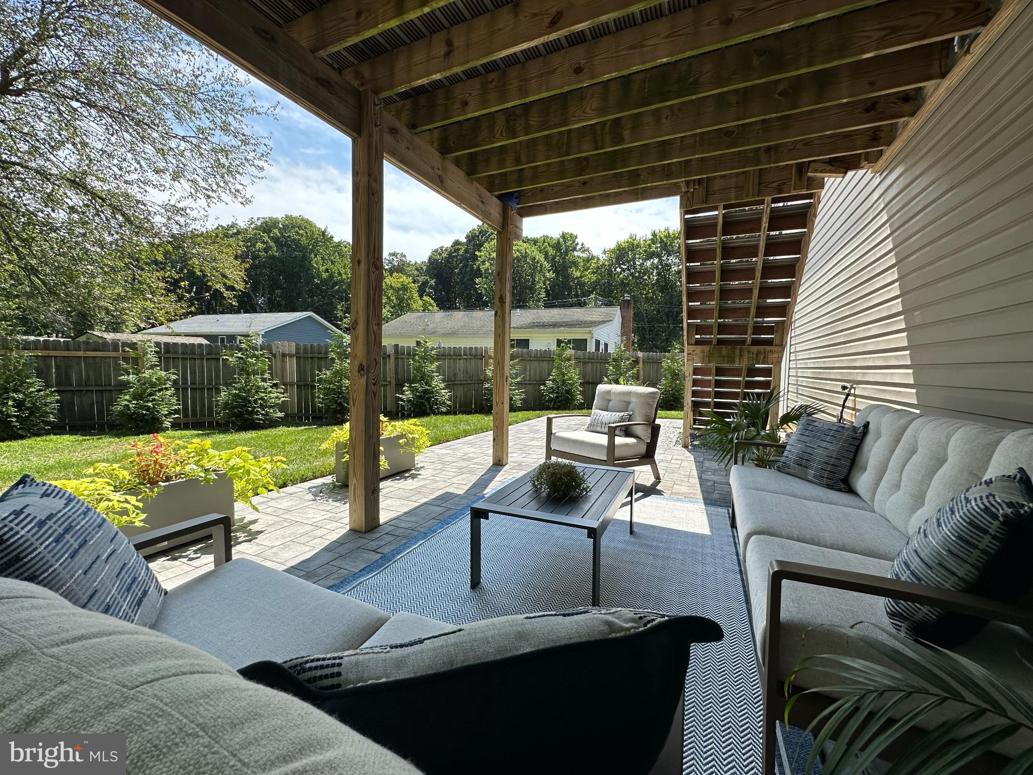 1221 Cox Neck Road Chester, MD 21619 - Photo 29 of 35 a view of a patio with couches chairs and a wooden floor