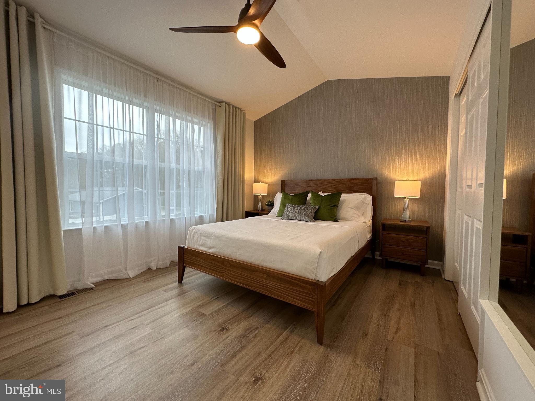 1221 Cox Neck Road Chester, MD 21619 - Photo 10 of 35 a bedroom with a large bed and a large window