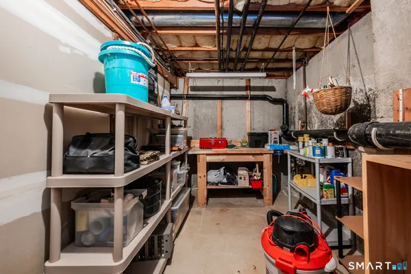 a utility room with fridge dryer and washer