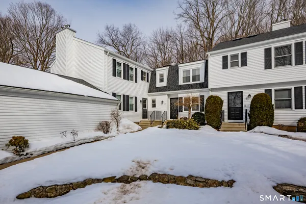 a view of a house with snow on the road