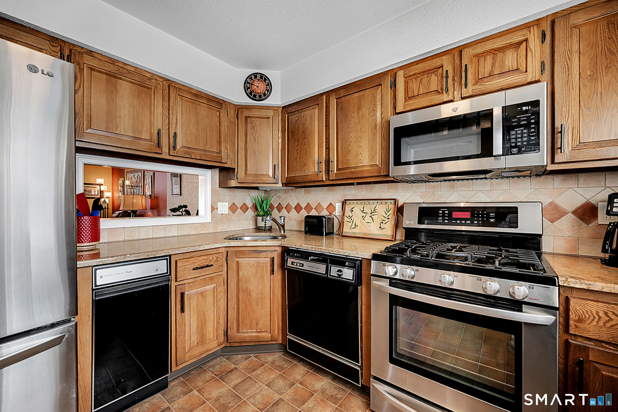 319 Thomaston Road, Unit 13 Watertown, CT 06795 - Photo 5 of 30 a kitchen with stainless steel appliances granite countertop a stove top oven a sink and cabinets