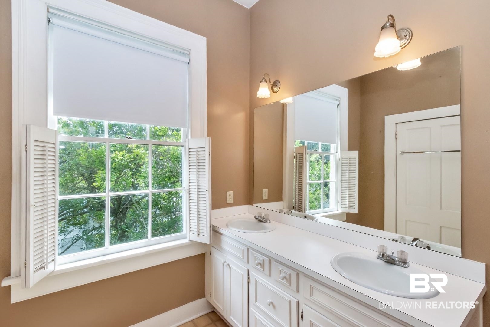959 Dauphin Street Mobile, AL 36604 - Photo 22 of 43 Bathroom with dual vanity and a healthy amount of sunlight