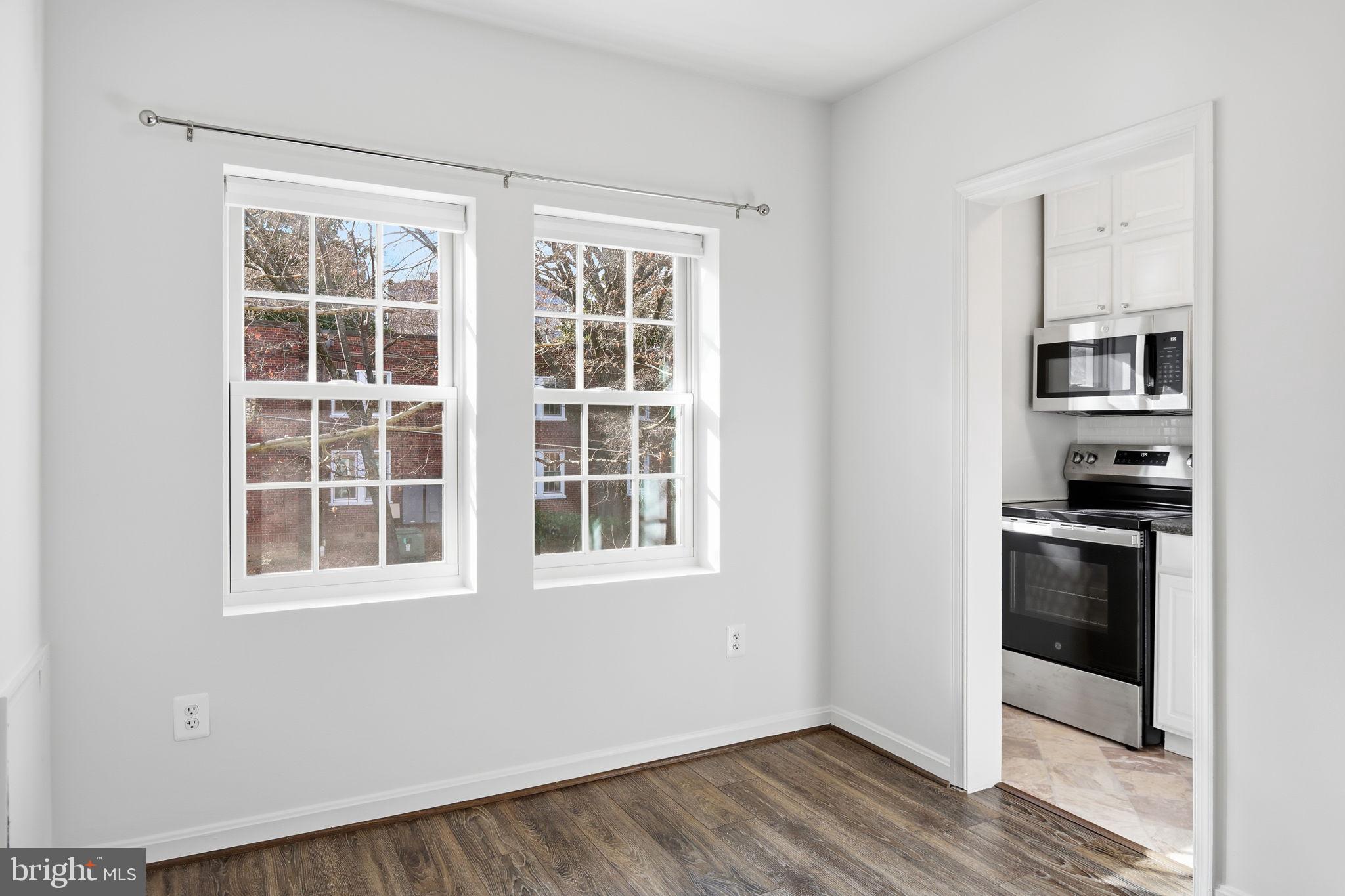 1744 North Rhodes Street, Unit 310 Arlington, VA 22201 - Photo 11 of 24 a view of kitchen with stainless steel appliances and wooden floor