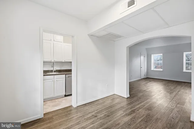 a view of a kitchen with a sink and dishwasher wooden floor