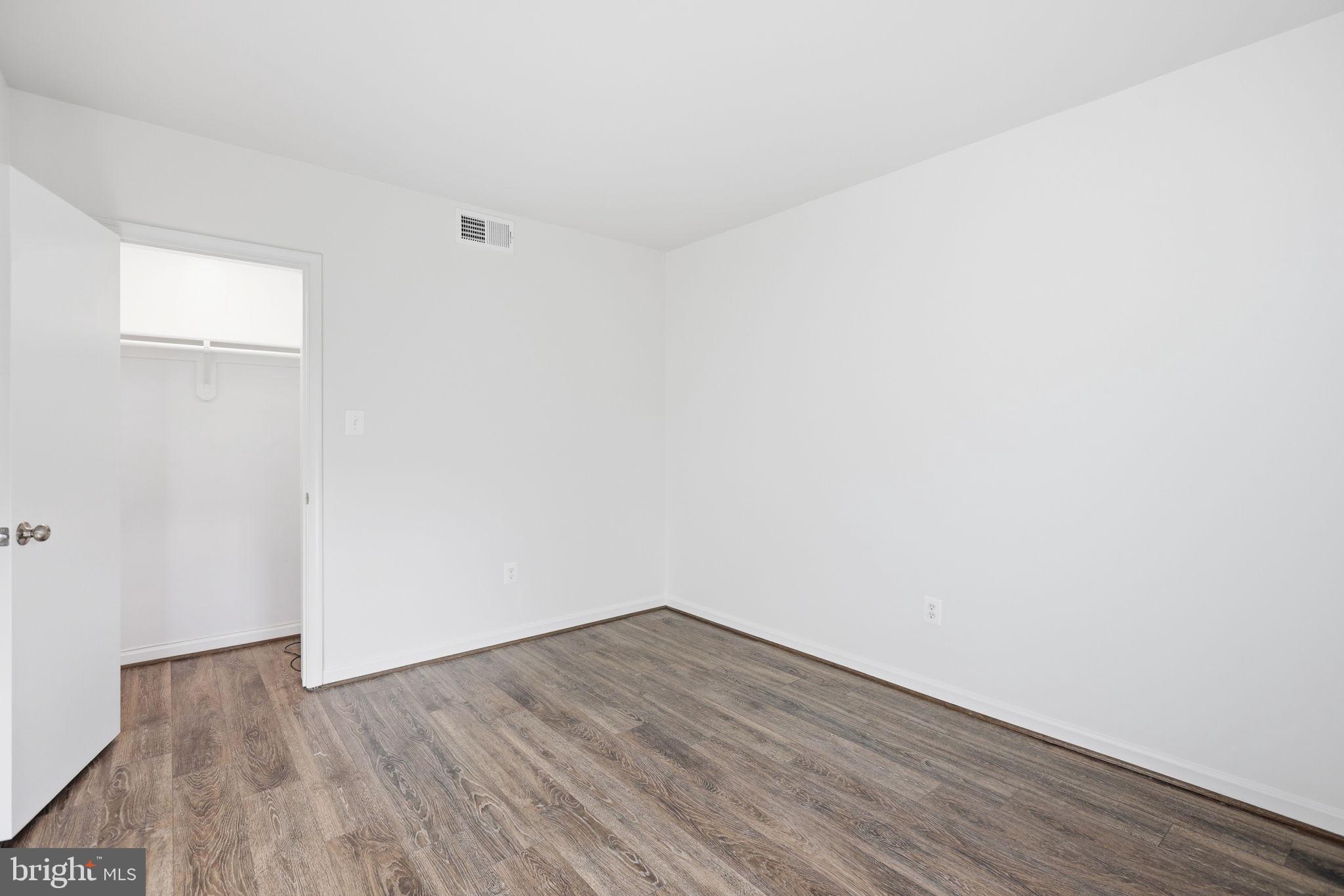1744 North Rhodes Street, Unit 310 Arlington, VA 22201 - Photo 17 of 24 a view of an empty room with wooden floor