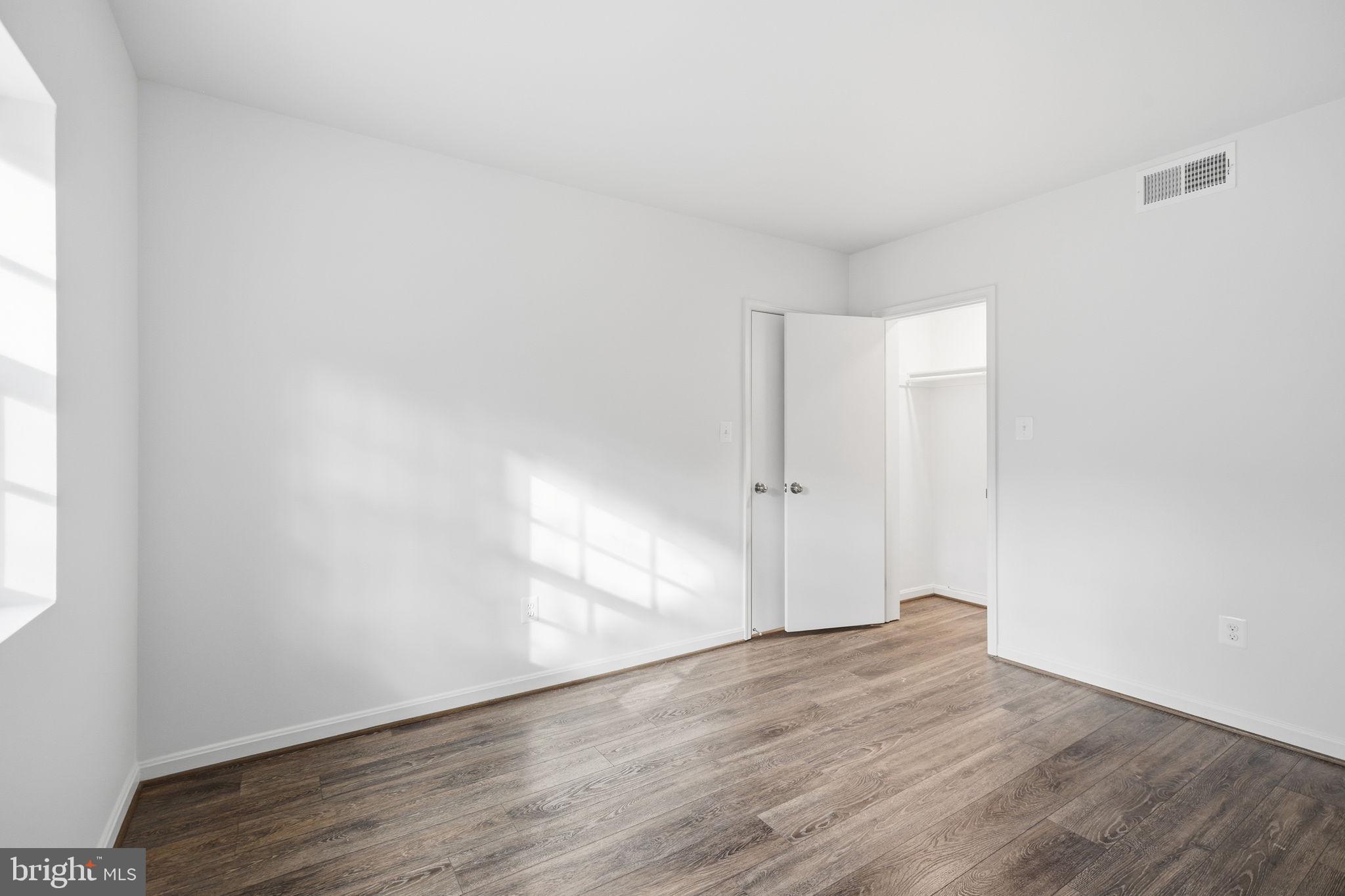 1744 North Rhodes Street, Unit 310 Arlington, VA 22201 - Photo 18 of 24 an empty room with wooden floor